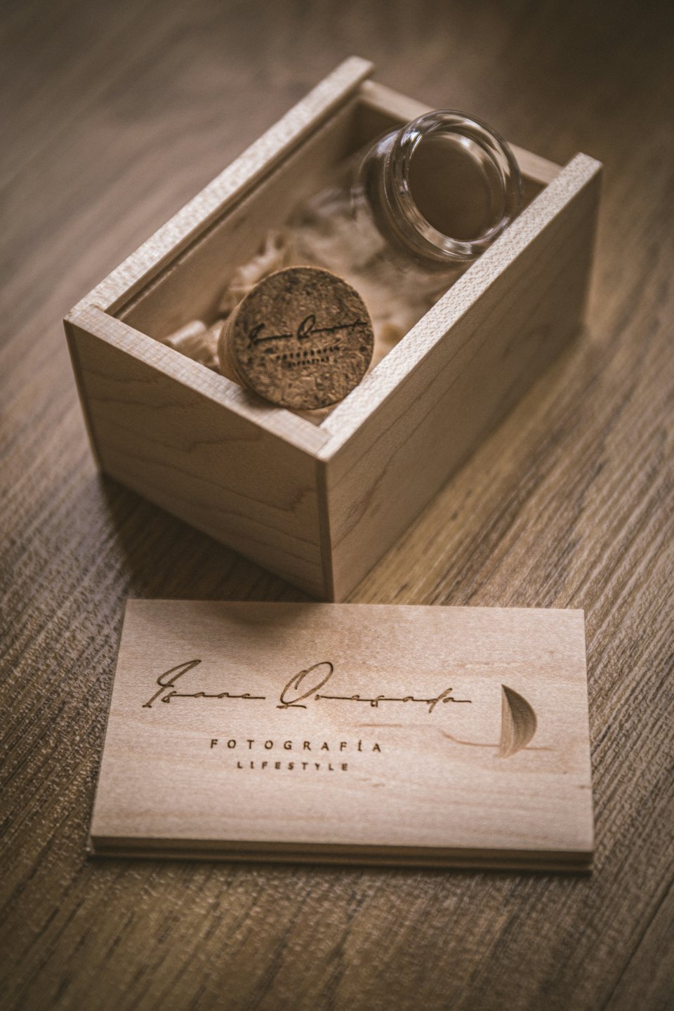 Wooden box with jar and USB drive on wood.