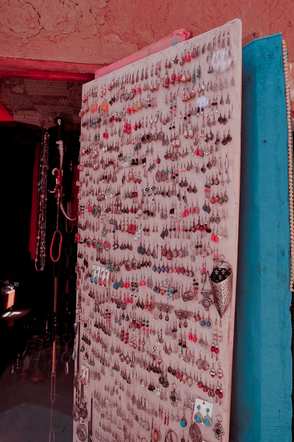 Display board with handmade earrings featuring silver and colorful beads.