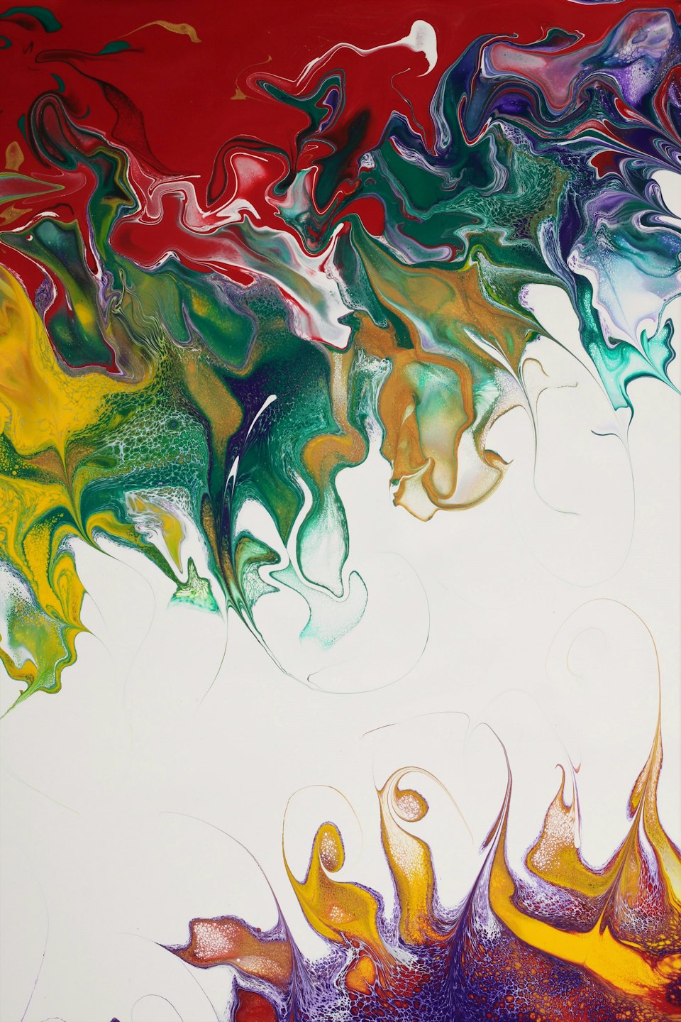 Swirling red green yellow purple and gold paint on canvas.